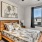bedroom with bed and wall art and large window