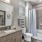 bathroom with bathtub and large mirror