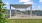 bench and picnic table under pergola with pet washing station